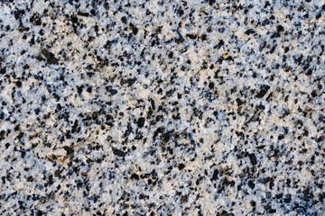 The texture of light pink natural granite with black spots