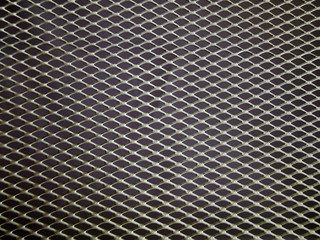 
gray metal mesh on a dark background abstract background