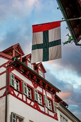 Flag of Konstanz against half-timbered historical house in the center of Konstanz City, Baden-Wurttemberg, Germany.