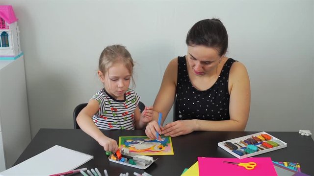 Mother with Daughter Working with Plasticine. Making a Picture of Swan with Colorful Modeling Clay. Home Education and Early Development Concept