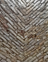 A vertical background with stone bricks in a downward facing v shape