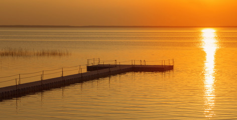 Naklejka na ściany i meble pontoon pier at beautiful summer sunset