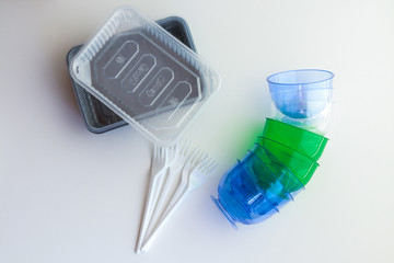 plastic black containers, blue cups and forks kill our planet, clog it.