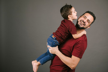 Obraz premium Portrait of a father and son playing in studio