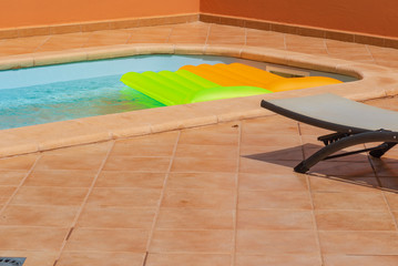private swimming pool in the villa with colored mattresses
