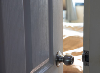 White wooden door which is ajar opened