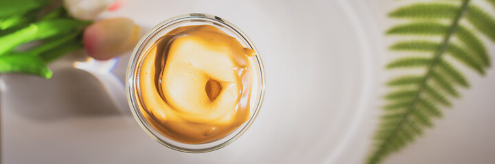 flat lay favorite and trend of summer drink from dalgona or frothy coffee on white and tulip background