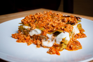 Close up of homemade Italian style green lasagna made with meat sauce and mozzarella cheese