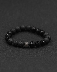 Round stone bracelets on a black background. Natural stone jewelry bracelets. bracelet made of stones.