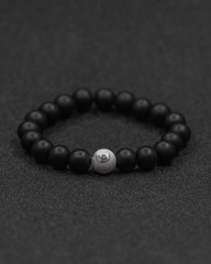 Round stone bracelets on a black background. Natural stone jewelry bracelets. bracelet made of stones.