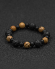 Round stone bracelets on a black background. Natural stone jewelry bracelets. bracelet made of stones.