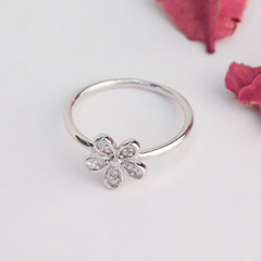 silver ring in the flower shape decorated with diamond