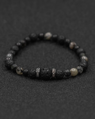 Round stone bracelets on a black background. Natural stone jewelry bracelets. bracelet made of stones.
