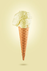 Lemon ice cream cone on yellow background