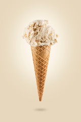 Vanilla ice cream cone on colored background