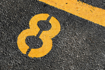 Asphalt parking lot with yellow lot line and yellow lot number 8, eight, eighth.
