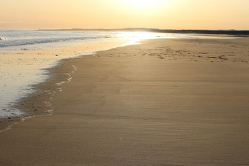 Sun reflection on sea and sand