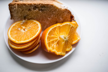 Naklejka na ściany i meble Sliced orange on a white plate