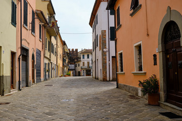 Main street of little town Porcari. Solo Backpacker Trekking on the Via Francigena from Lucca to Siena. Walking between nature, history, churches,