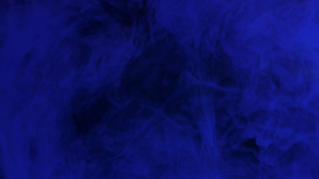 Dark blue ink mixing in water, swirling softly underwater with copy space. Colored acrylic cloud of paint isolated. Colorful abstract smoke explosion animation. Universe, space. Art background. 4K