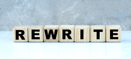 concept of the word REWRITE on cubes on a gray background