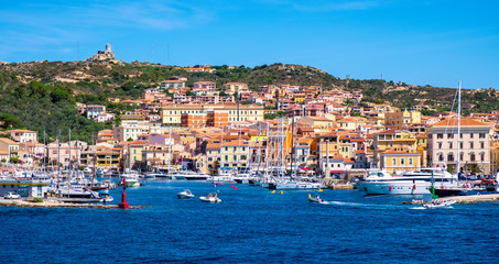 Panoramic view of La Maddalena old town quarter in Sardinia, Italy with port at the Tyrrhenian Sea coastline and island mountains interior in background