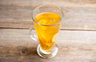 Healthy hot beverage with lemon, ginger and spices for protection in flu season. Selective focus. Shallow depth of field.