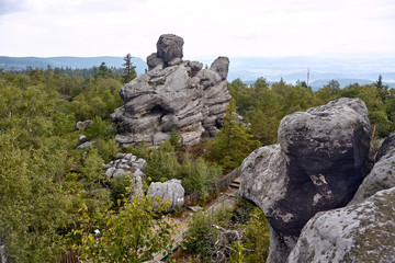 Rock formations and Rock Labyrinth hiking trail seen  from top of Liczyrzepa Throne (Tron Liczyrzepy) rock formation nearby Szczeliniec Wielki peak in Table Mountains, Poland. - obrazy, fototapety, plakaty