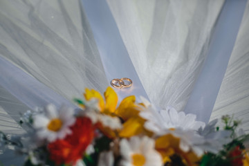 wedding rings and flowers