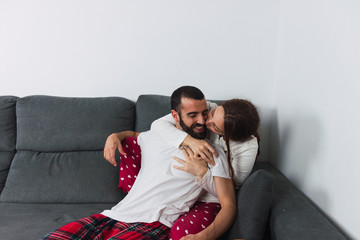 Couple Laughing Together On Couch