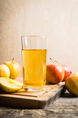 Apple juice with freshly harvested apples on the rustic background. Selective focus. Shallow depth of field.