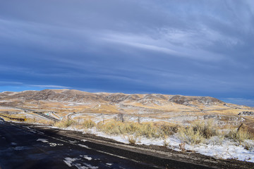 Snow covered road and highway with cloudy sky from Dinosaur Ridge, Colorado, USA