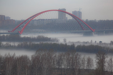 Fototapeta na wymiar Bugrinskiy bridge in fog Novosibirsk, Siberia