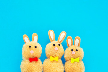 Cute toy Easter bunnies on a blue background