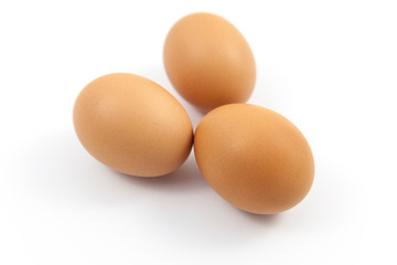Brown eggs on white background