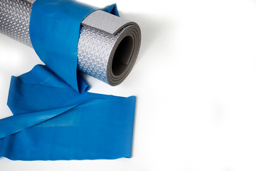 Training rubber and exercise mat on a white background