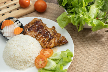 Rice with teriyaki chicken grill with side dish of vegetables (Chicken Teriyaki don in Japanese Style) - Wooden table