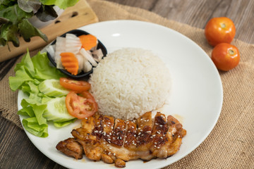 Rice with teriyaki chicken grill with side dish of vegetables (Chicken Teriyaki don in Japanese Style) - Wooden table