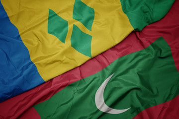 waving colorful flag of maldives and national flag of saint vincent and the grenadines. - obrazy, fototapety, plakaty