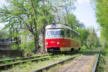 Fototapeta na wymiar Old red tram in the forest. In the spring