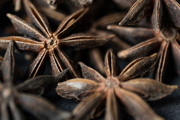 Anise stars on stone, concrete background. Detailed view, close-up.