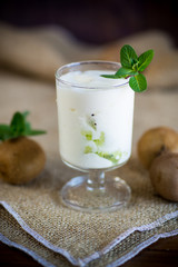 Homemade sweet yogurt with slices of ripe green kiwi in a glass