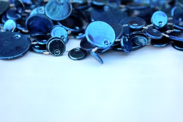 Blue shiny decoration on a white background. Christmas blue beads isolated on white with place for text. Close-up new year background with Christmas balls toned trendy classic blue color. holiday