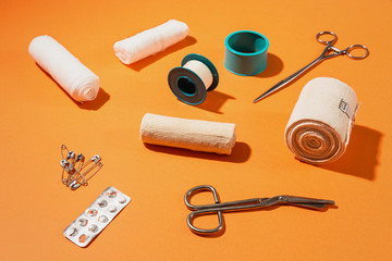 First aid kit items on top of colorful background.