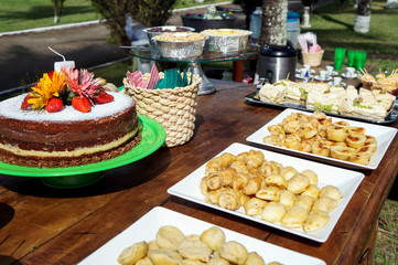 Naked cake with strawberry and flower. Small savory snacks. Child's 5th birthday.