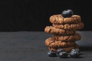 Fototapeta na wymiar Closeup photo of stack of homemade oatmeal cookies with chocolate and blueberry.