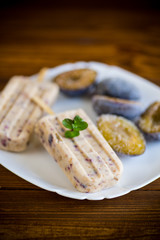 plum sweet homemade ice cream on a stick with slices of plum inside, in a plate