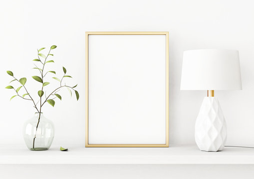 Interior poster mockup with vertical gold metal frame on the shelf with green tree branch in vase and lamp on empty white wall background. A4, A3 size format. 3D rendering, illustration.