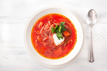 1 white plate of borscht with sour cream and herbs , Ukrainian soup