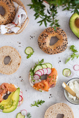 Breakfast flat lay of New York style bagels with philadelphia cheese, avocado, cured salmon